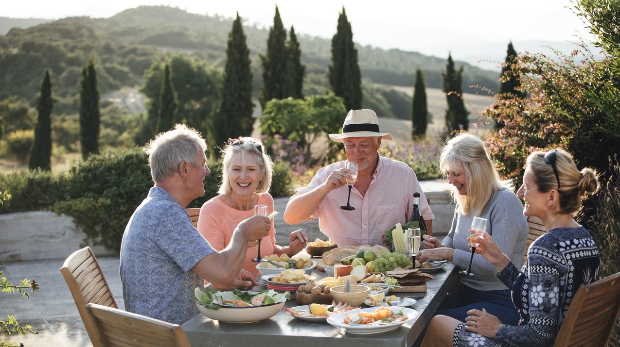 Retirees enjoying a meal together in the Italian countryside